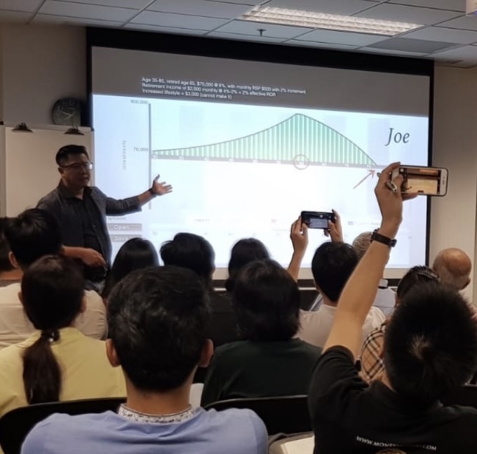 Hock Beng on stage at an industry event